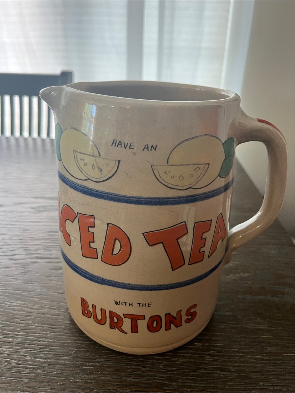 This is a vintage ceramic iced tea pitcher featuring hand-painted design.